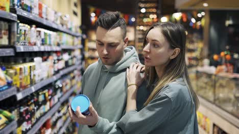 Couple-in-the-grocery-store.-The-girl-and-her-boyfriend-chooses-what-she-wants-to-buy.-Daily