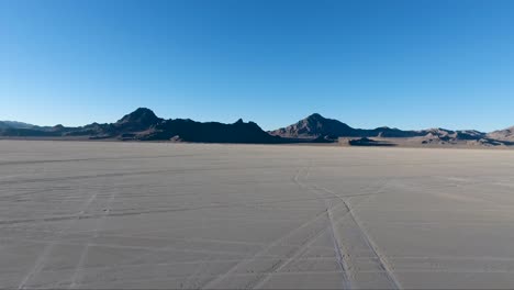 flying over the bonneville salt flats in northwestern utah reveal white salt and tire tracks