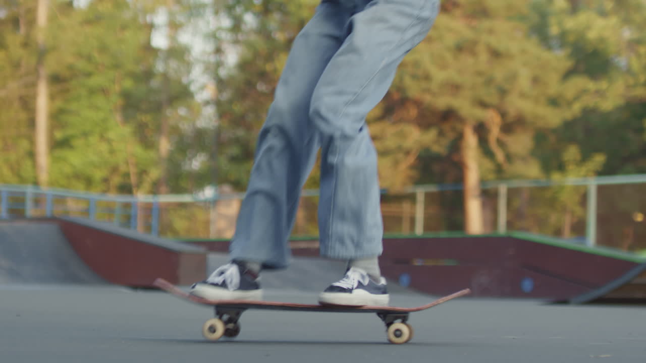 Slowmo of Unrecognizable Teenager Doing Kickflip on Skateboard