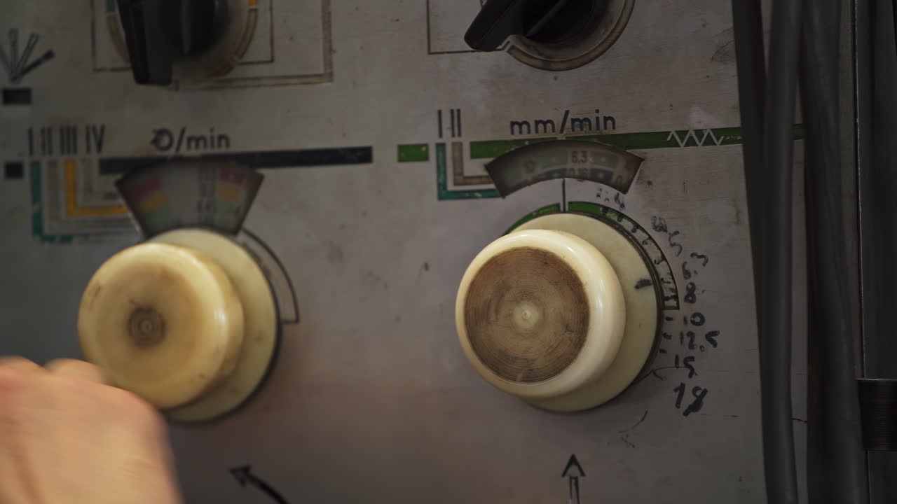 Person Adjusting Controls on Industrial Machine