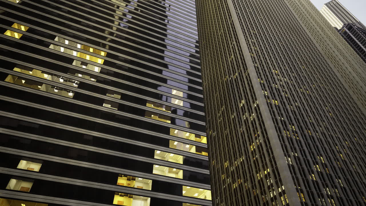 Skyscrapers with illuminated windows in urban environment at dusk