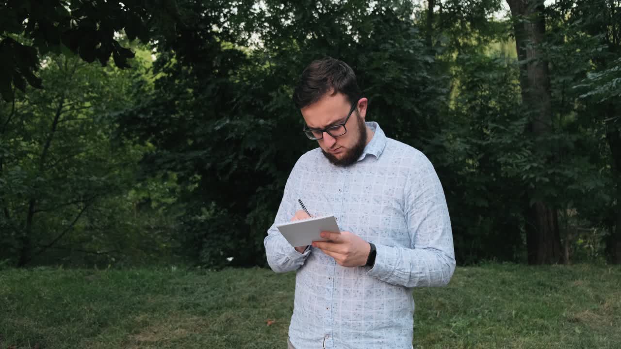 Man writes in a notebook