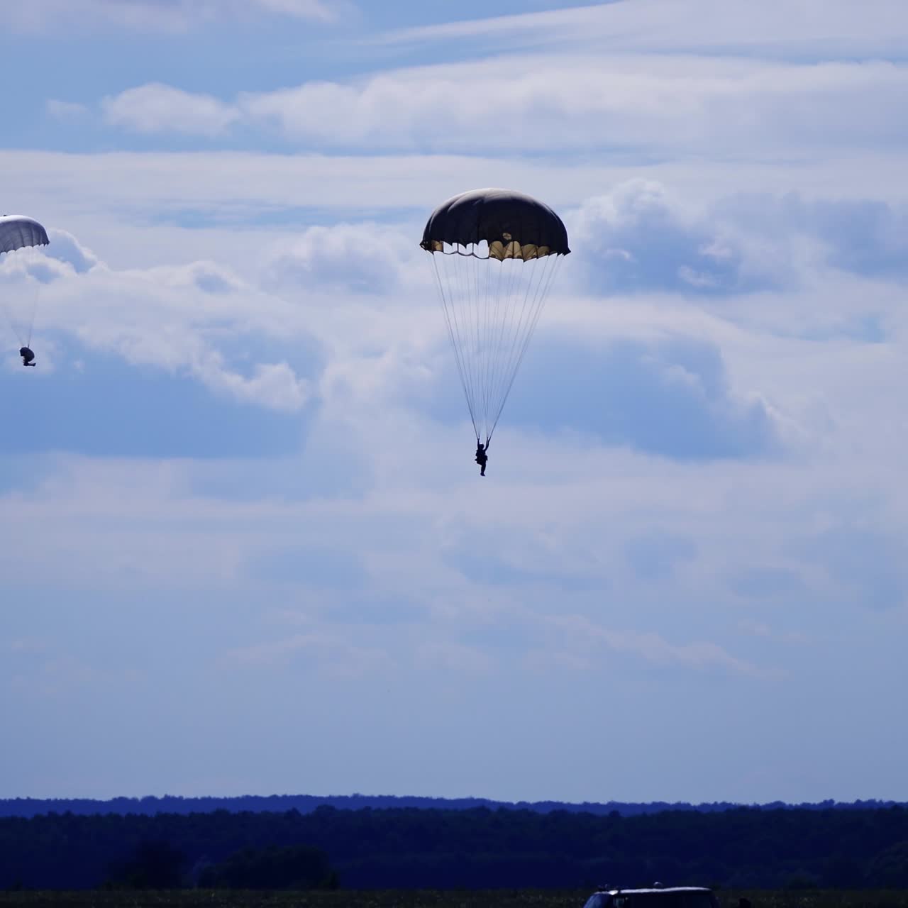 Two parachutists descending to the ground. Skydiving, parachute jumping, extreme sport concept