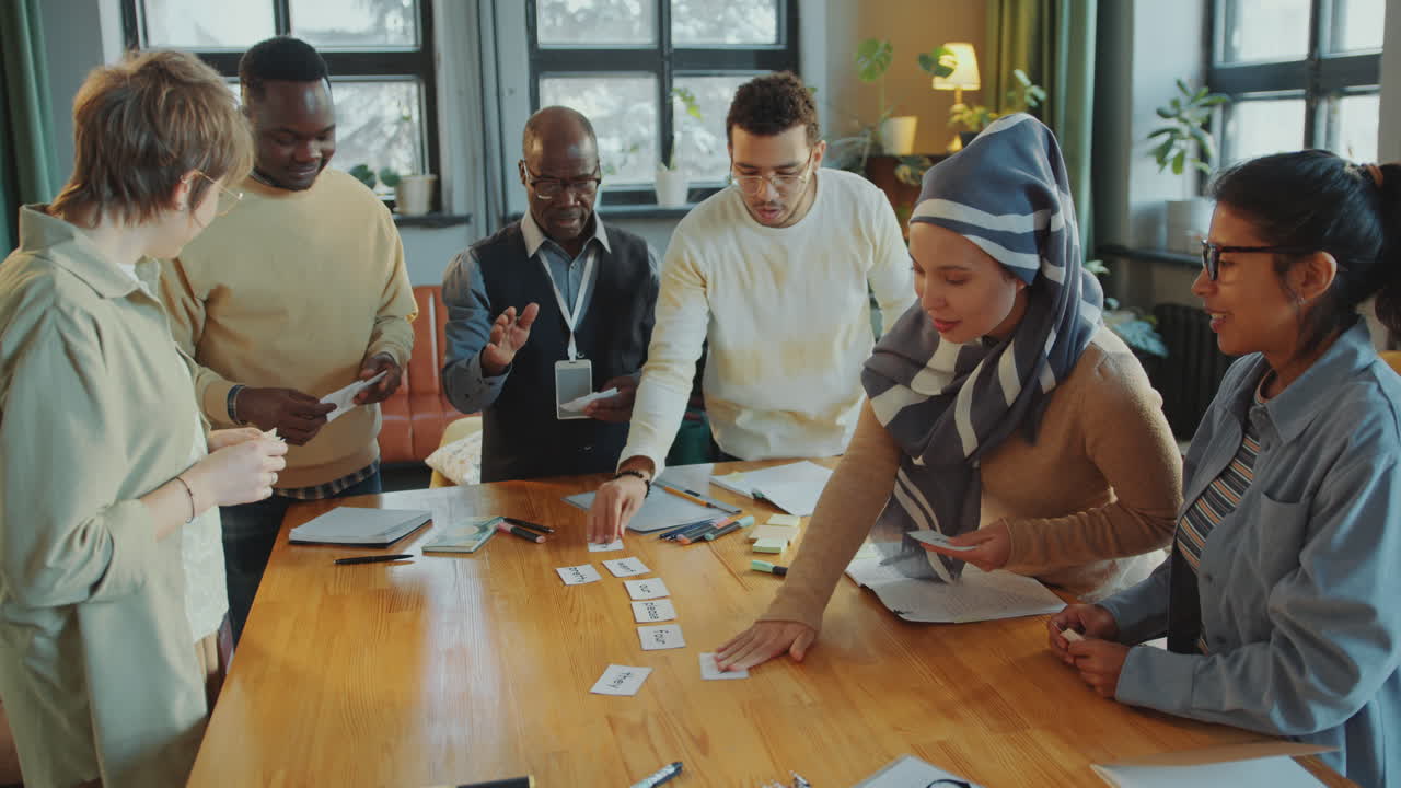 Group of Immigrant Students and Teacher Learning English Words on Cards