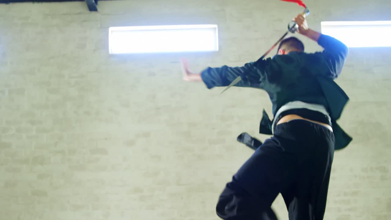 Kung fu fighter practicing martial arts with sword 4k