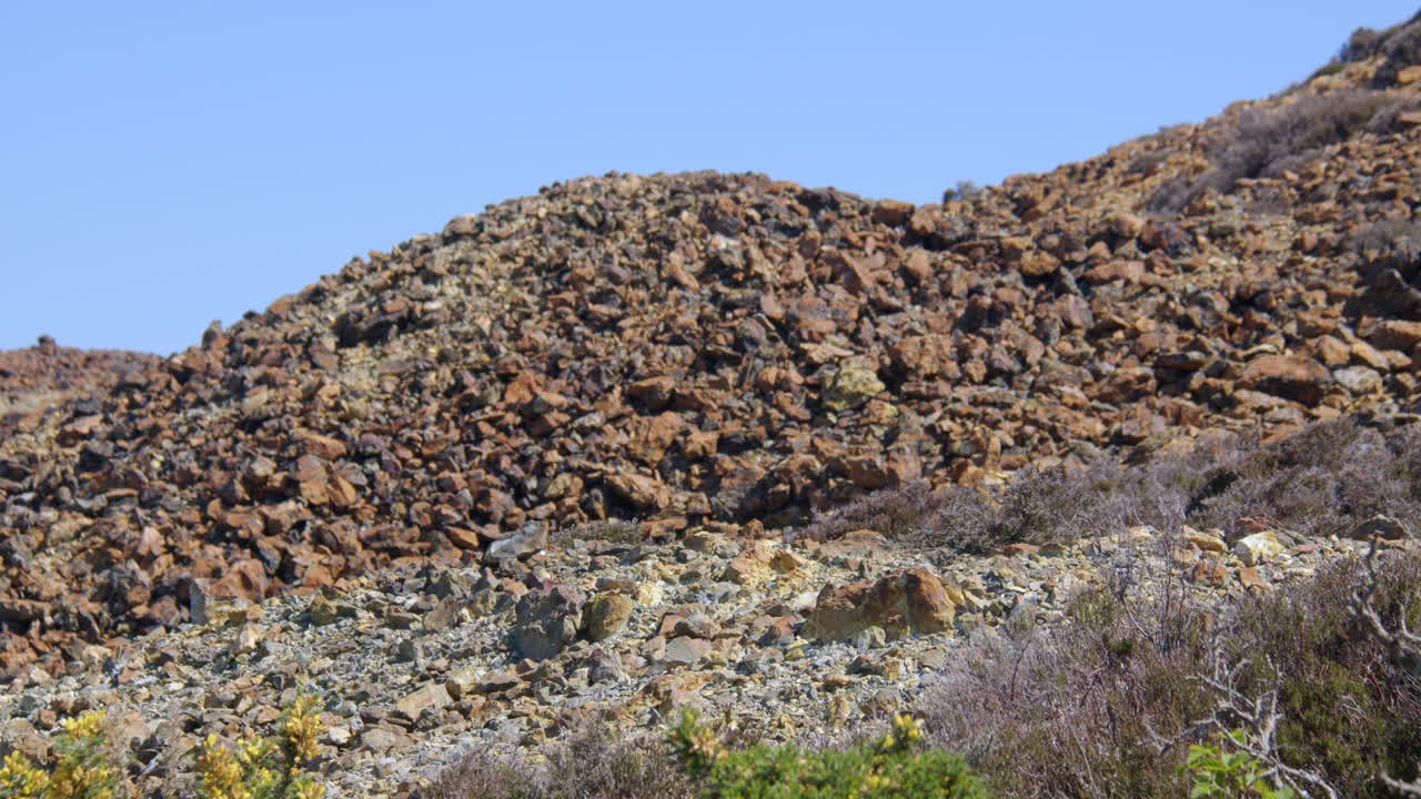 Slow zoom in to the roasted ore slag heap at mynydd parys mountain copper mine