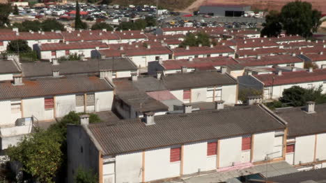 Neighborhood-on-the-outskirts-of-Lisbon-with-low-rise-housing-with-tin-roofs,-top-view