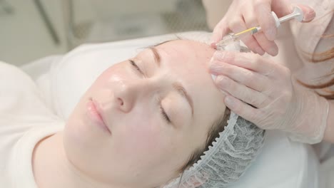 cosmetologist performing facial injection procedure