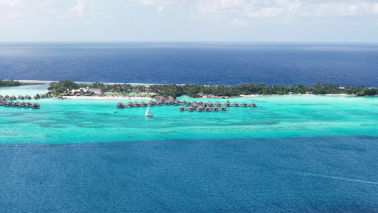Drone Shot of Bora Bora Island French Polynesia, Luxury Tropical Resort Bungalows Over Lagoon Water