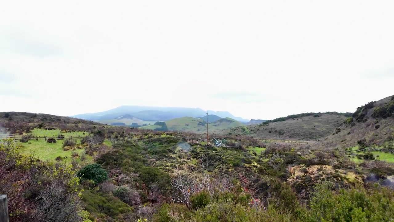 Scenic walking trail with volcanic steam rising from Furnas do Enxofre nature reserve on Terceira Island in the Azores Portugal