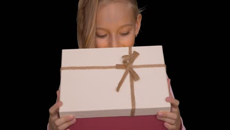 young caucasian girl open gift box front view. holiday eve. alpha channel chroma key transparent background. happy young girl opening gift box. shining light from gift box.