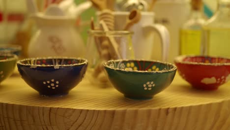 colorful decorative bowls on a wooden display