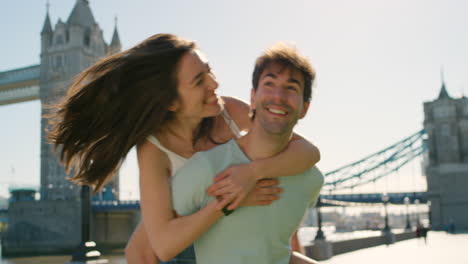 a young man giving his girlfriend a piggyback ride