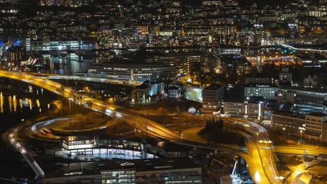 timelapse of busy traffic in spaghetti junction in the middle of city at night