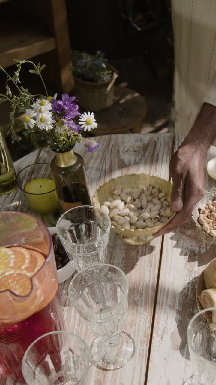 Outdoor table setting with snacks, drinks, and flowers for a summer gathering