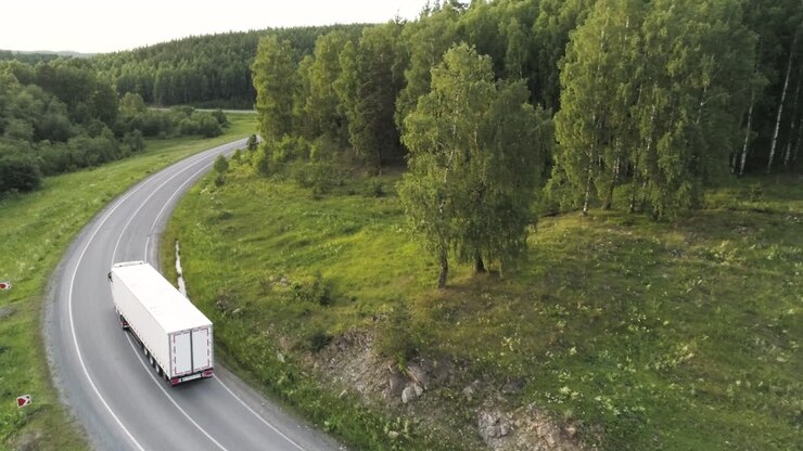 Truck on a winding road through a forest