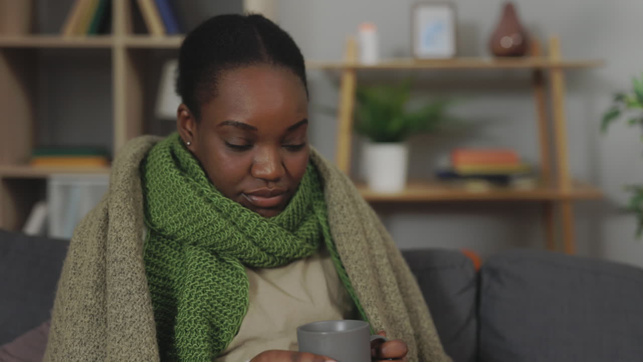 Woman feeling ill drinking hot beverage