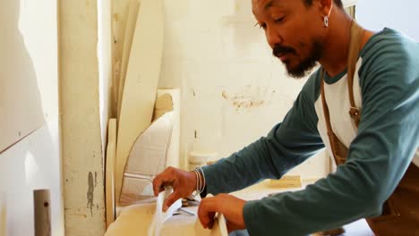 surfboard maker working in workshop 4k