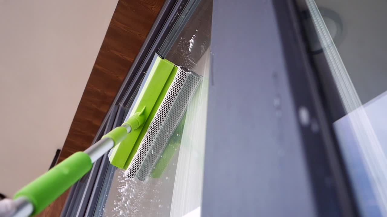Cleaning a window with a squeegee
