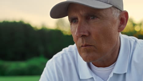 Pensioner-looking-golf-play-at-country-club-course.-Focused-man-enjoy-sunset.