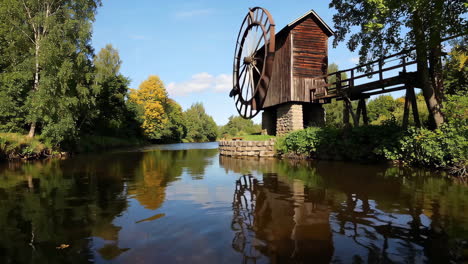old wooden watermill by a river