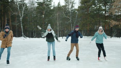 friends ice skating outdoors in winter