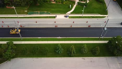 drone shot of roller smoothing out new asphalt on a city street