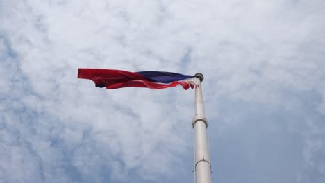 captured from under the pole as this flag waves on the left side while showing this lovely sky with clouds, philippine national flag