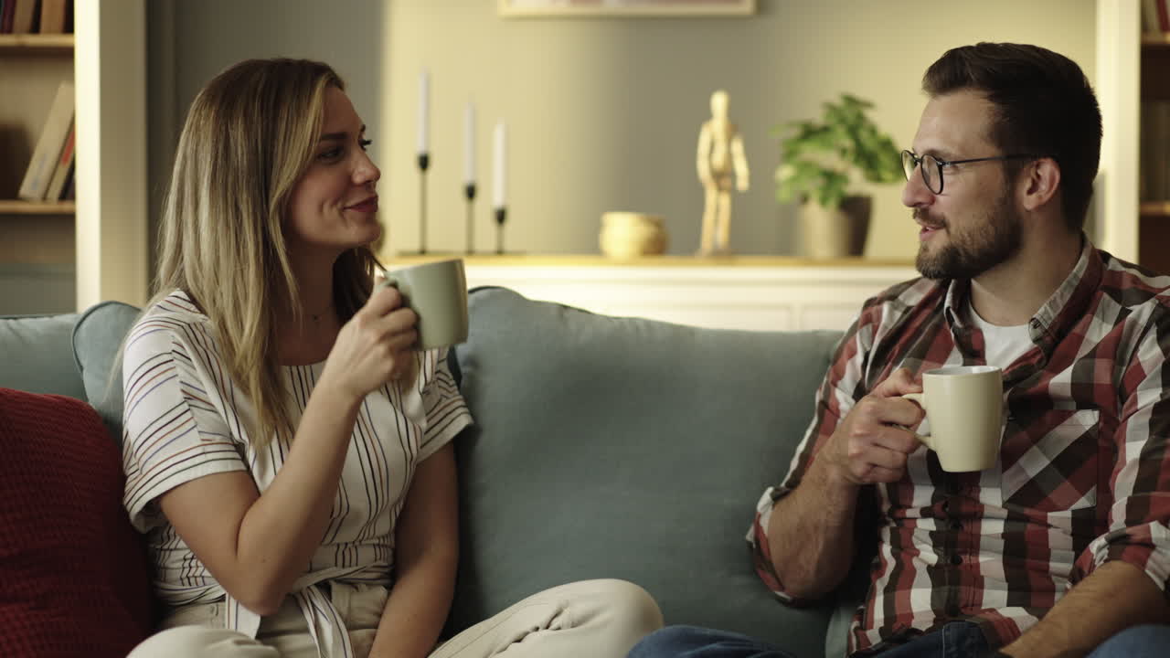 Couple relaxing on couch with coffee