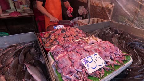 assorted seafood displayed at a market stall