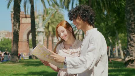 closeup tourist couple looking map outdoor. young man and woman searching way