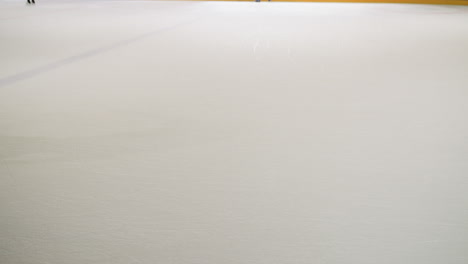 a boy wearing black trousers is seen skiing on a pristine white surface. capturing the action and motion of the skier