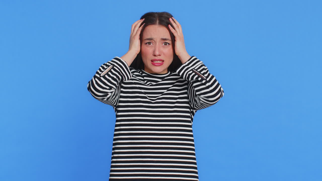 Scared fearful depressed young woman suffering phobia anxiety disorder expresses fear stress panic