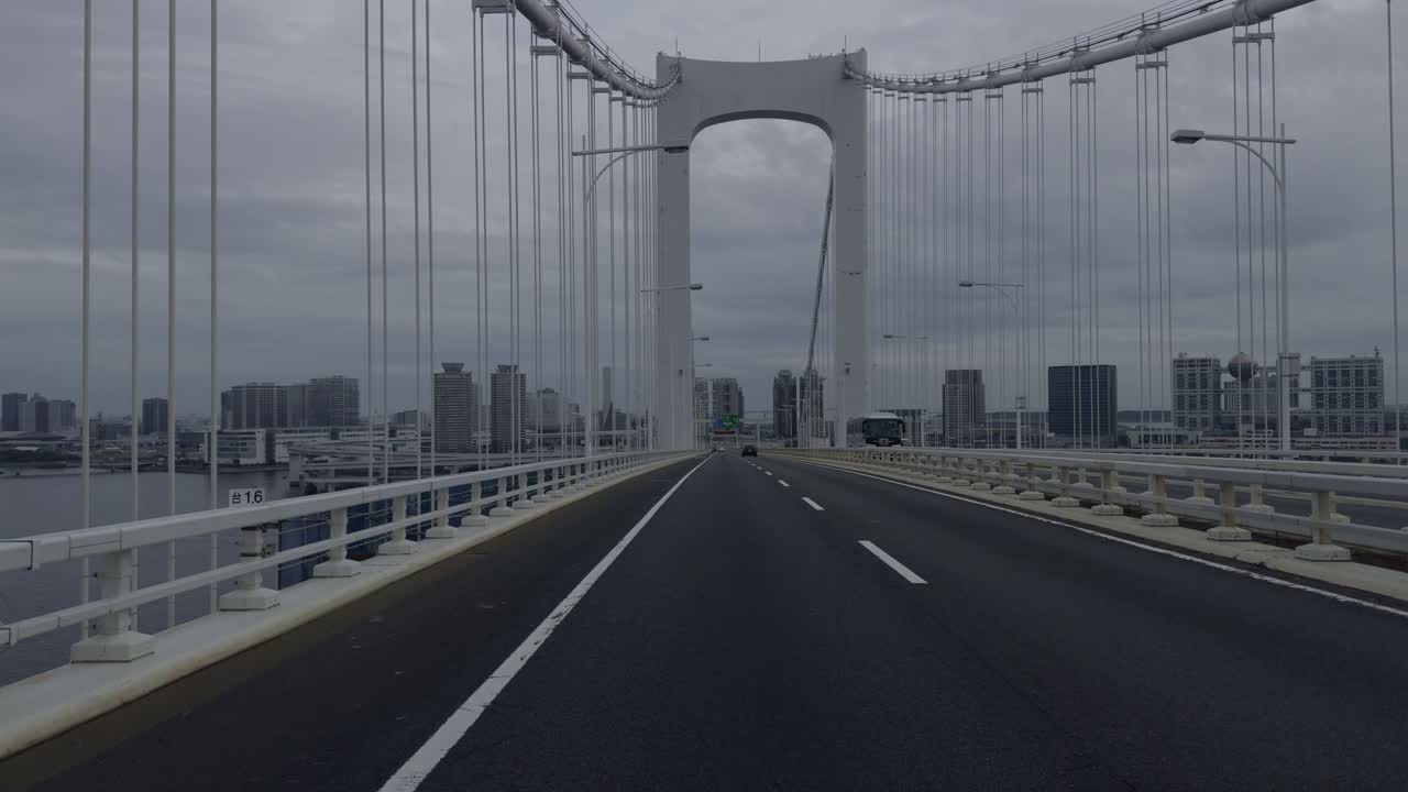 Tokyo Highway: Cloudy Blue Hour Views Experience the calm of Tokyo’s new territories by car, with soft blue hour light filtering through clouds