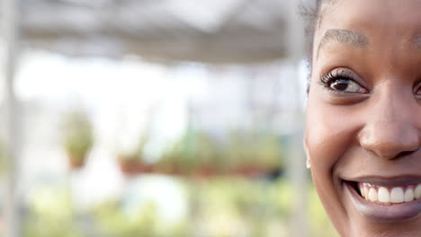 smiling woman enjoying peaceful moment surrounded by greenery in nursery, in greenhouse, copy space