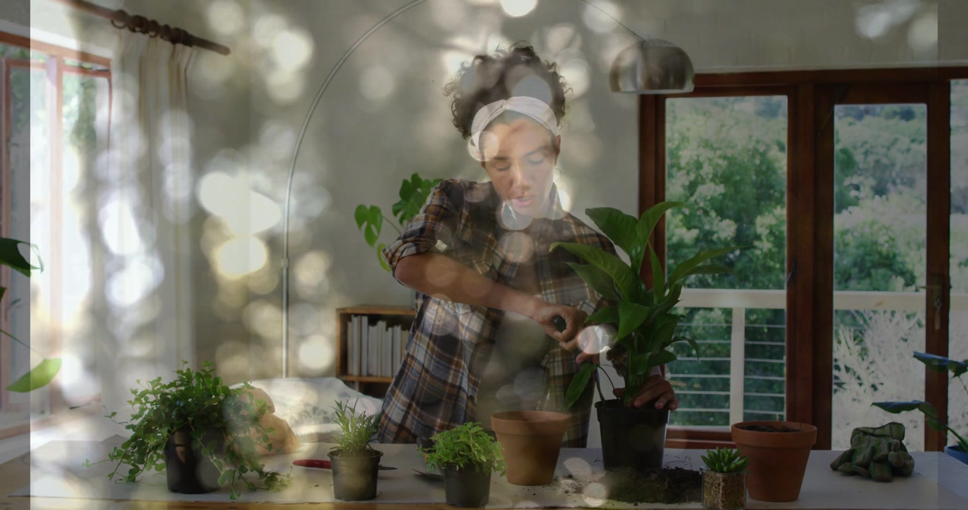 Mujer cogiendo una regadera, regando y trasplantando plantas para su cuidado, con una superposición de efecto bokeh en todo el encuadre.