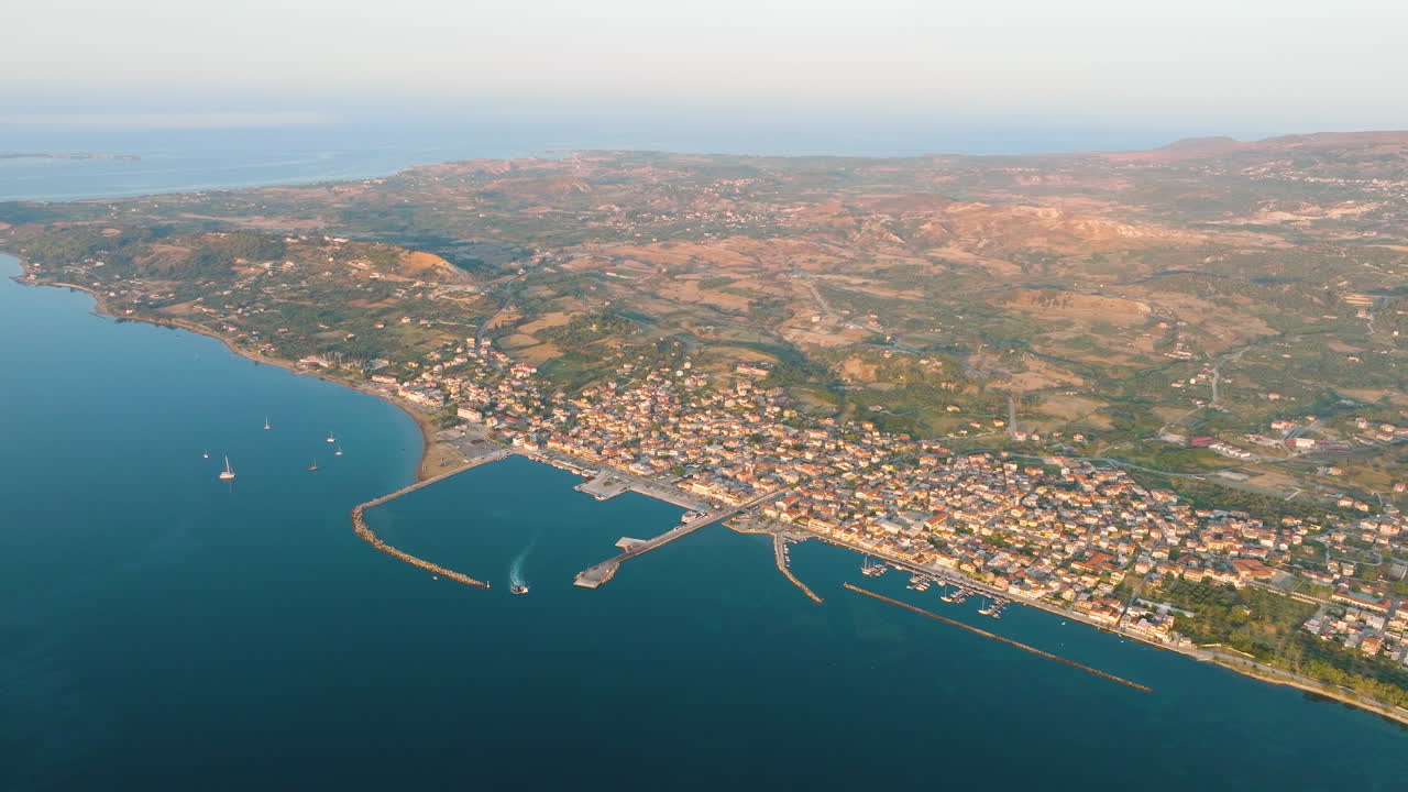 Aerial view of a coastal town with harbor and boats