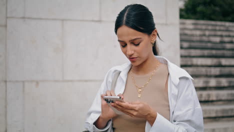 Talking-businesswoman-texting-smartphone-street-vertical.-Woman-typing-message