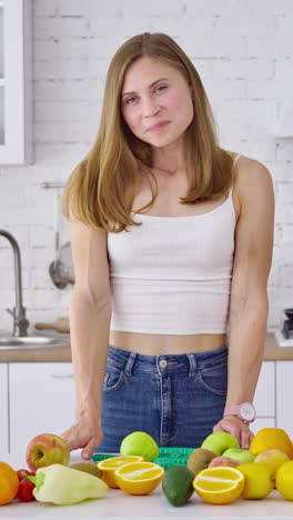pretty woman in her kitchen. portrait of smiling young housewife in modern kitchen. vertical video