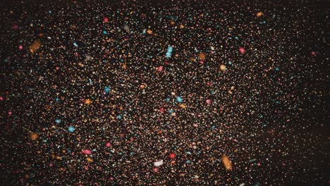 a mesmerizing collection of shimmering particles floating against a dark backdrop, creating an enchanting visual effect as light reflects off the colorful specks