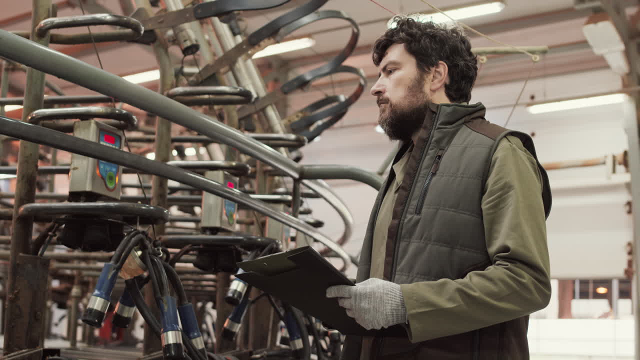 Caucasian Man Checking Industrial Milking Machine