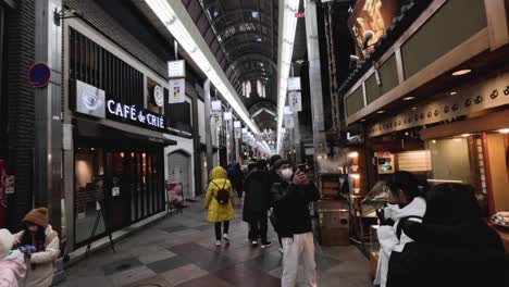 people walking through a bustling shopping arcade