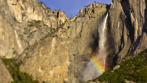 time lapse of yosemite falls waterfall with the sunshine hitting the water droplets and causing a rainbow - yosemite national park