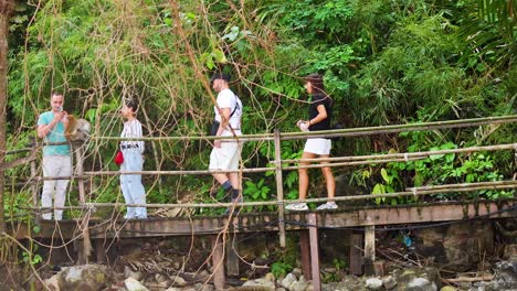 people strolling on a scenic wooden bridge