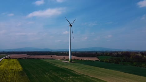 AERIAL---Wind-turbine-in-a-wind-energy-farm-in-Austria,-wide-shot-forward