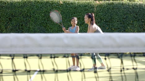 playing tennis, mother and child enjoying outdoor activity together