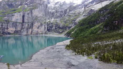 turquoise azure alpine lake oeschinensee in swiss alps mountains, switzerland