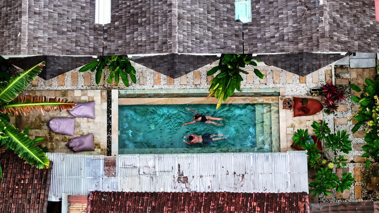 Private pool resort villa Bali Indonesia relaxing holiday swim, aerial drone top down view