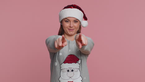 young christmas woman smiling excitedly and pointing finger to camera, choosing lucky lottery winner