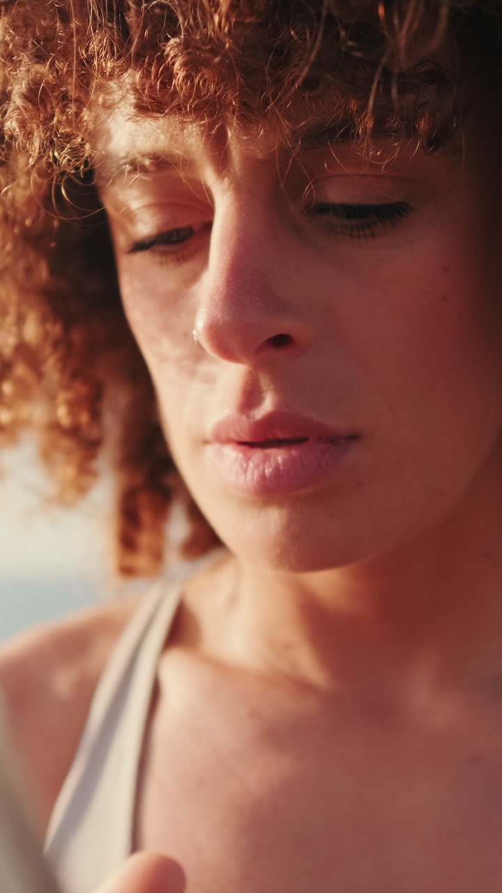 Woman Checks Fitness on Phone at Beach